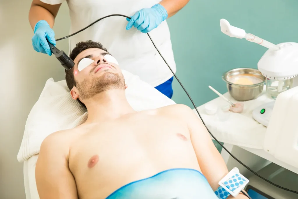young man getting laser hair removal at an aesthetic clinic